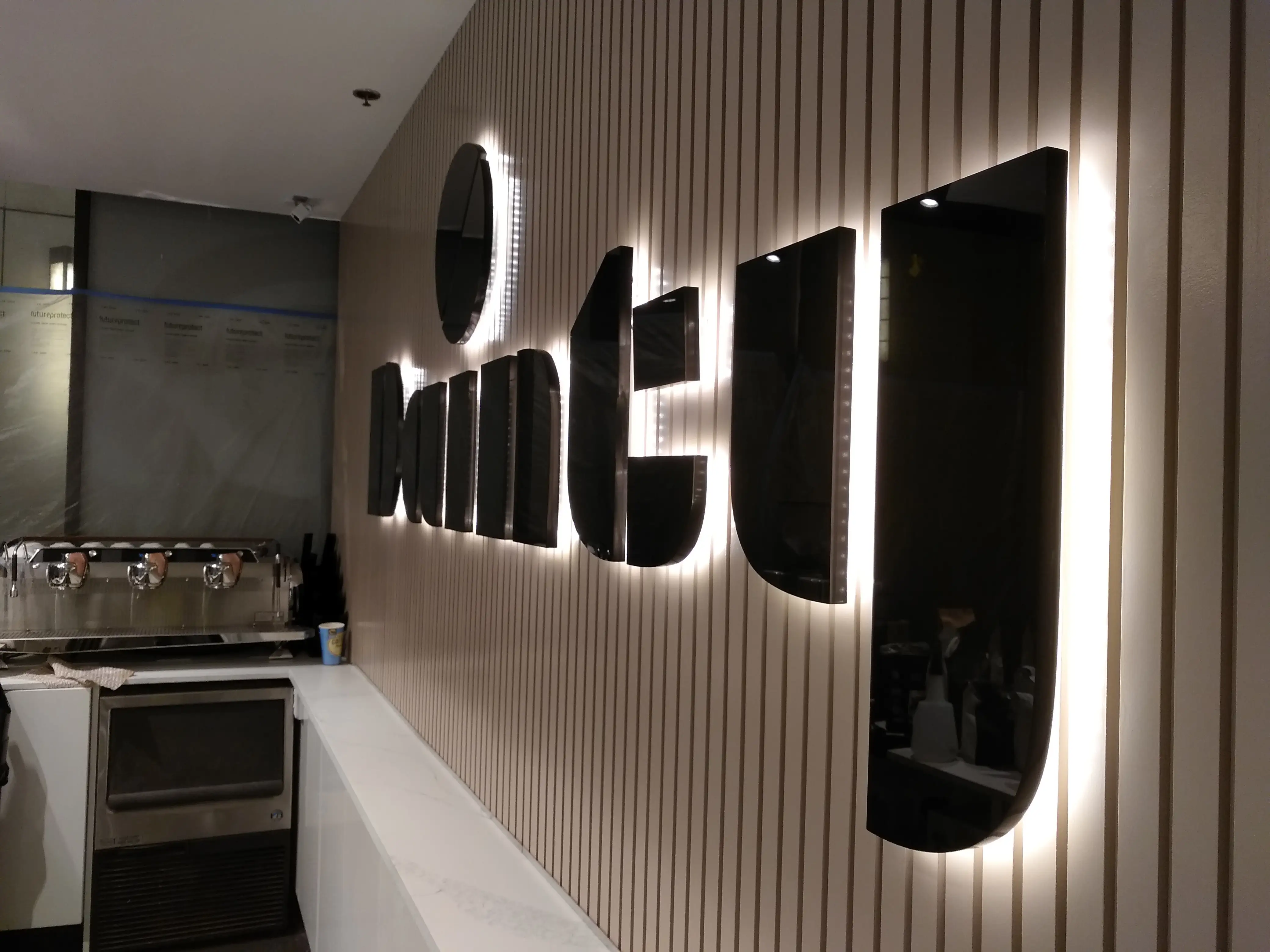 Hospitality brand sign viewed within the completed setting.