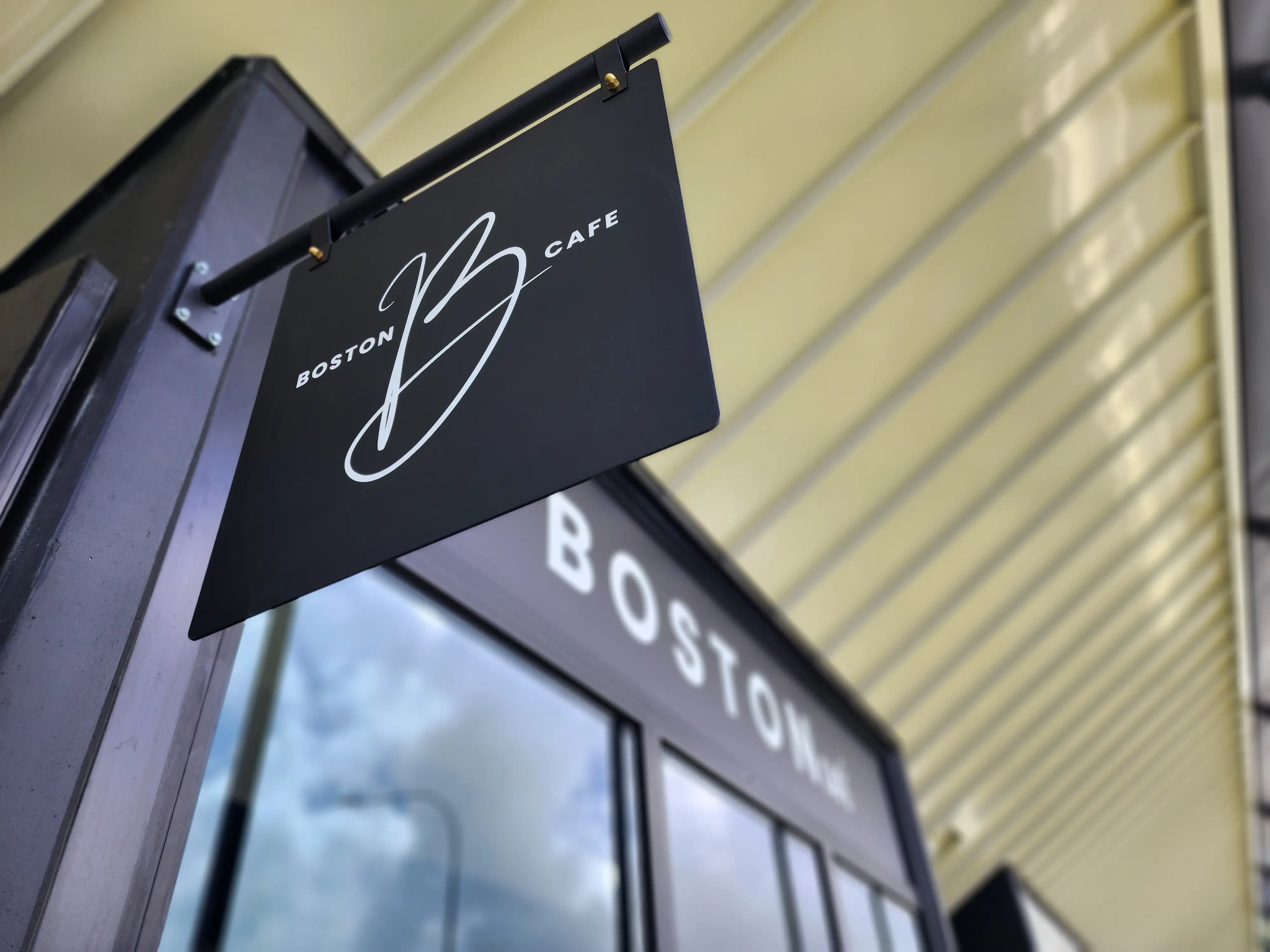Boston Cafe interior with illuminated overhead identity.