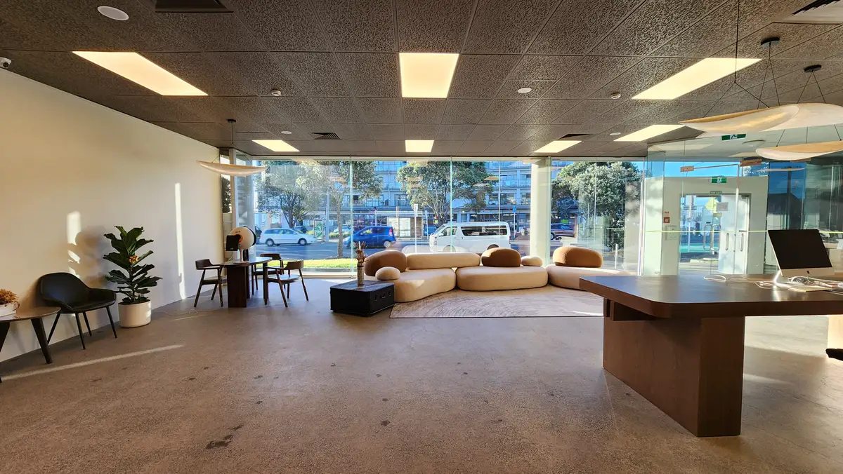 Curved openings connect the reception and adjoining interior spaces.
