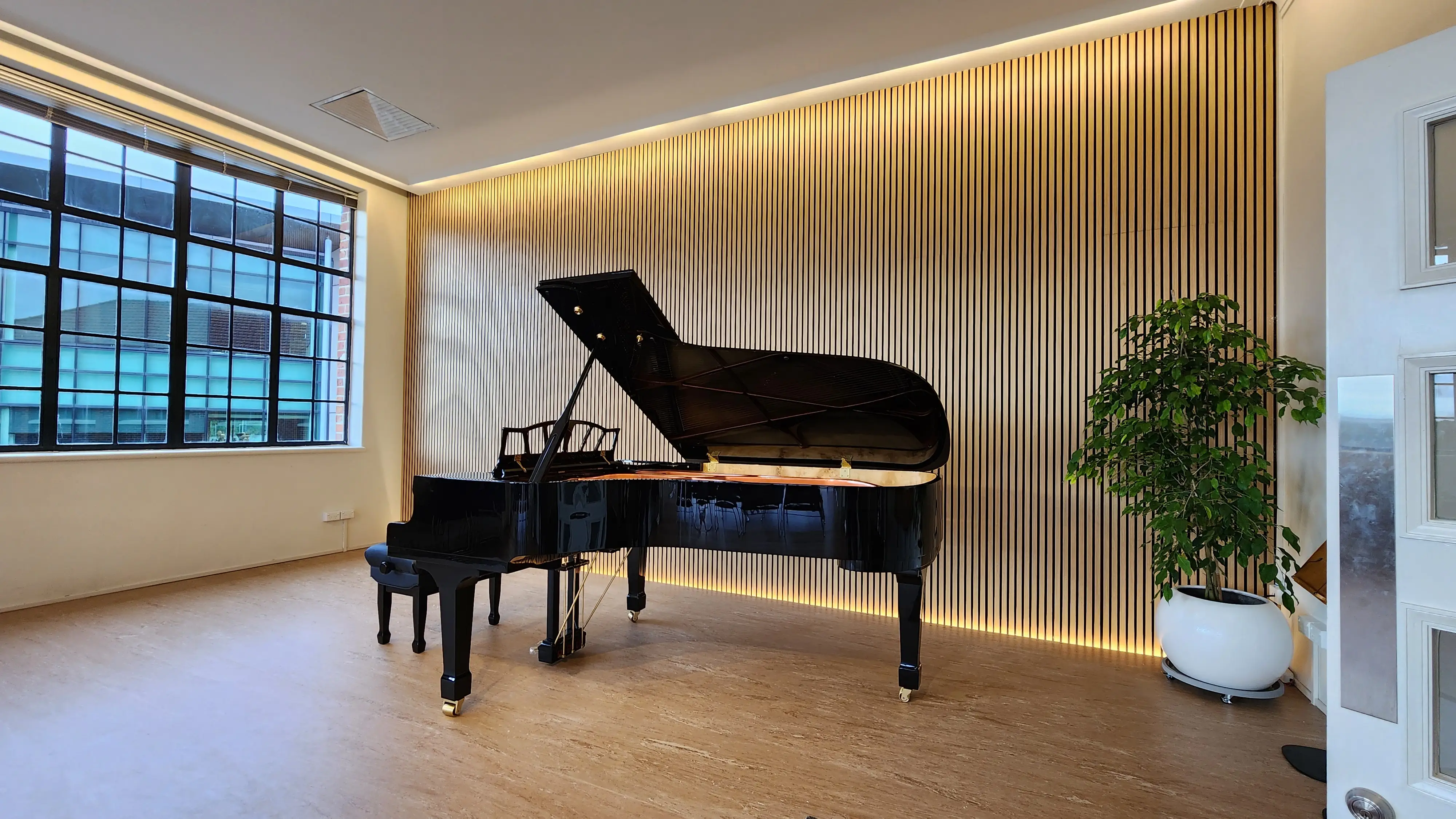 Timber-slat wall treatment within the completed music interior.