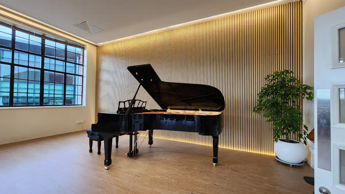 Timber-slat wall treatment within the completed music interior.
