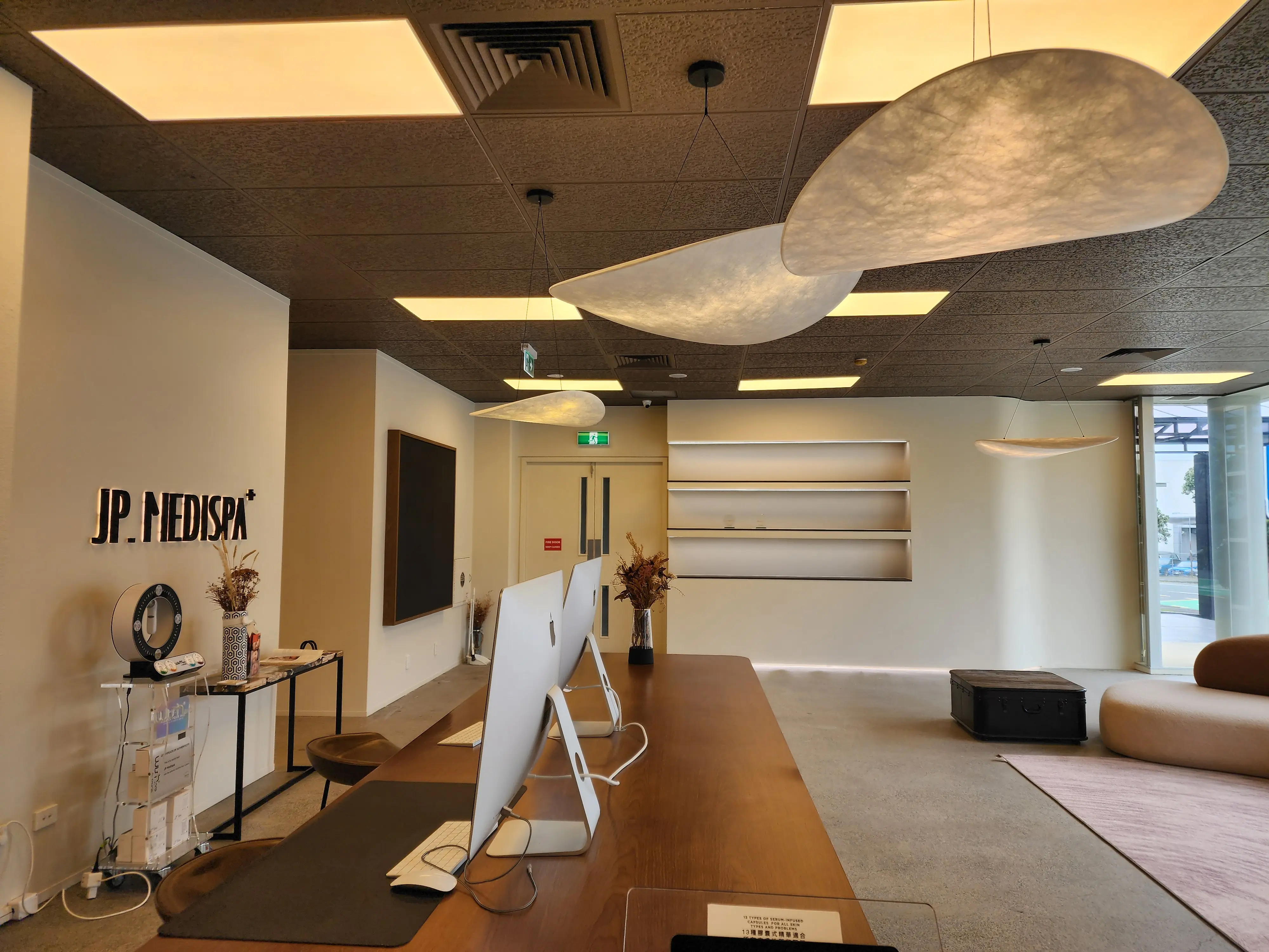JP Medi Spa reception with recessed product displays and integrated lighting.