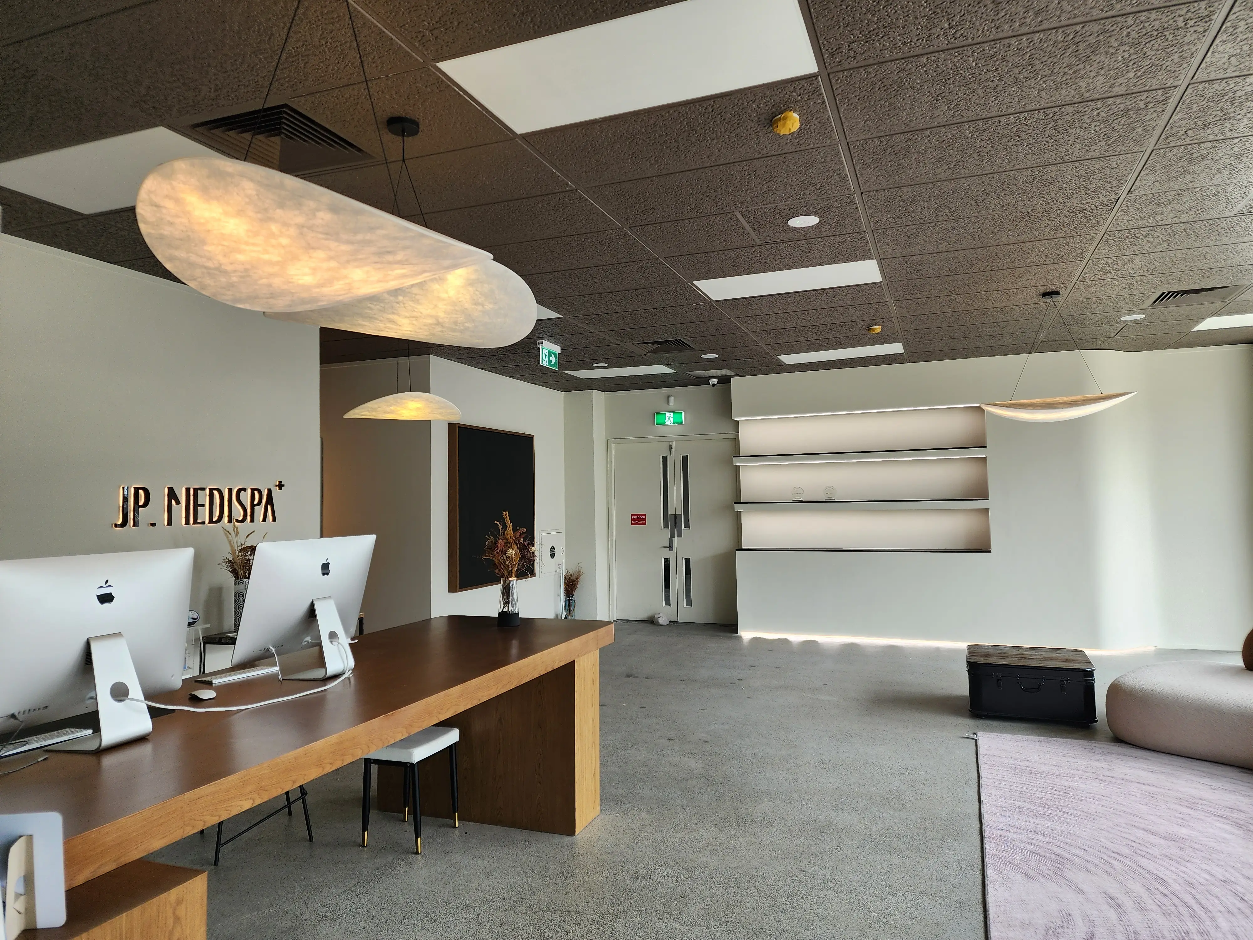 Curved openings connect the reception and adjoining interior spaces.