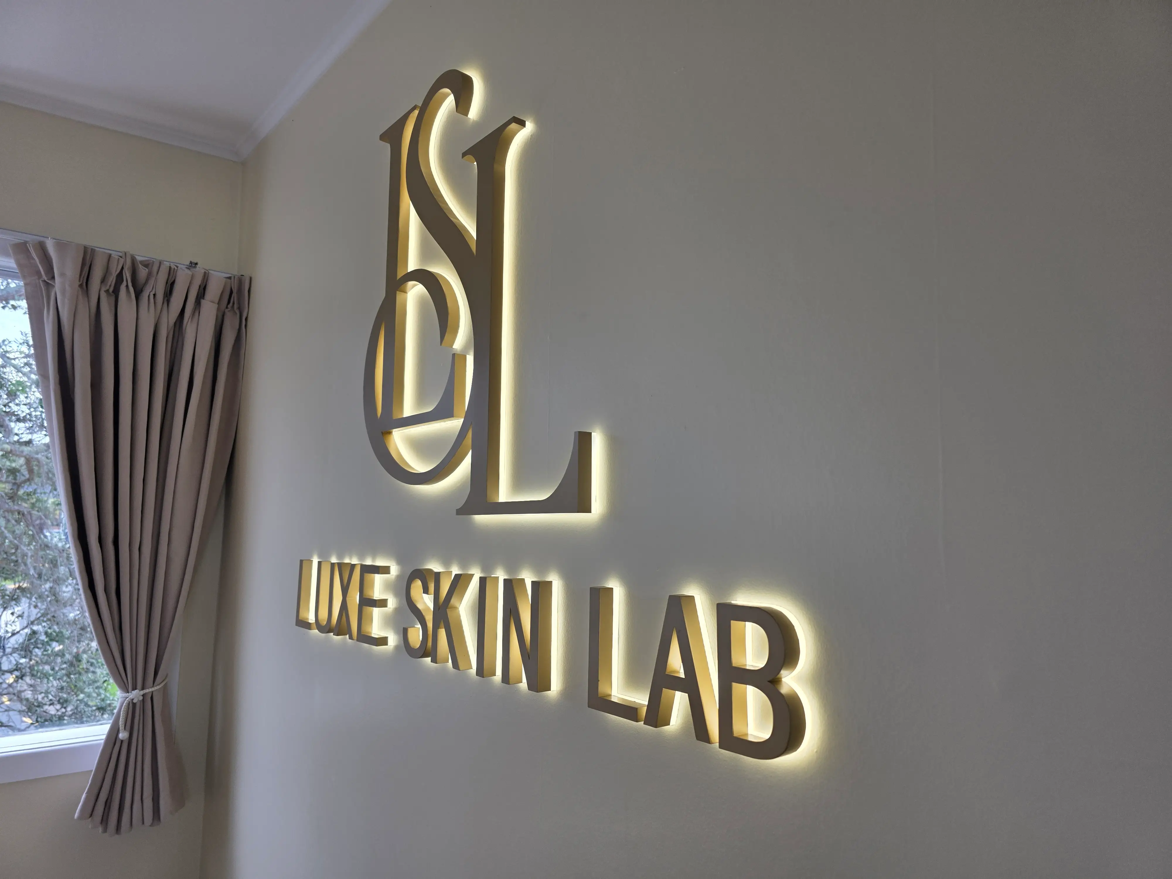 Illuminated Luxe Skin Lab identity within the completed interior.