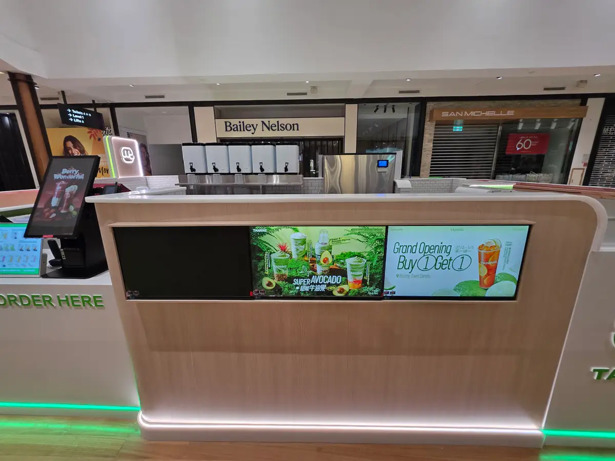 Illuminated service counter at TANING Botany Town Centre.
