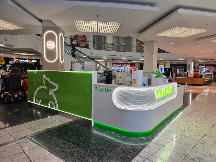 Curved illuminated tea kiosk at TANING Westfield St Lukes.