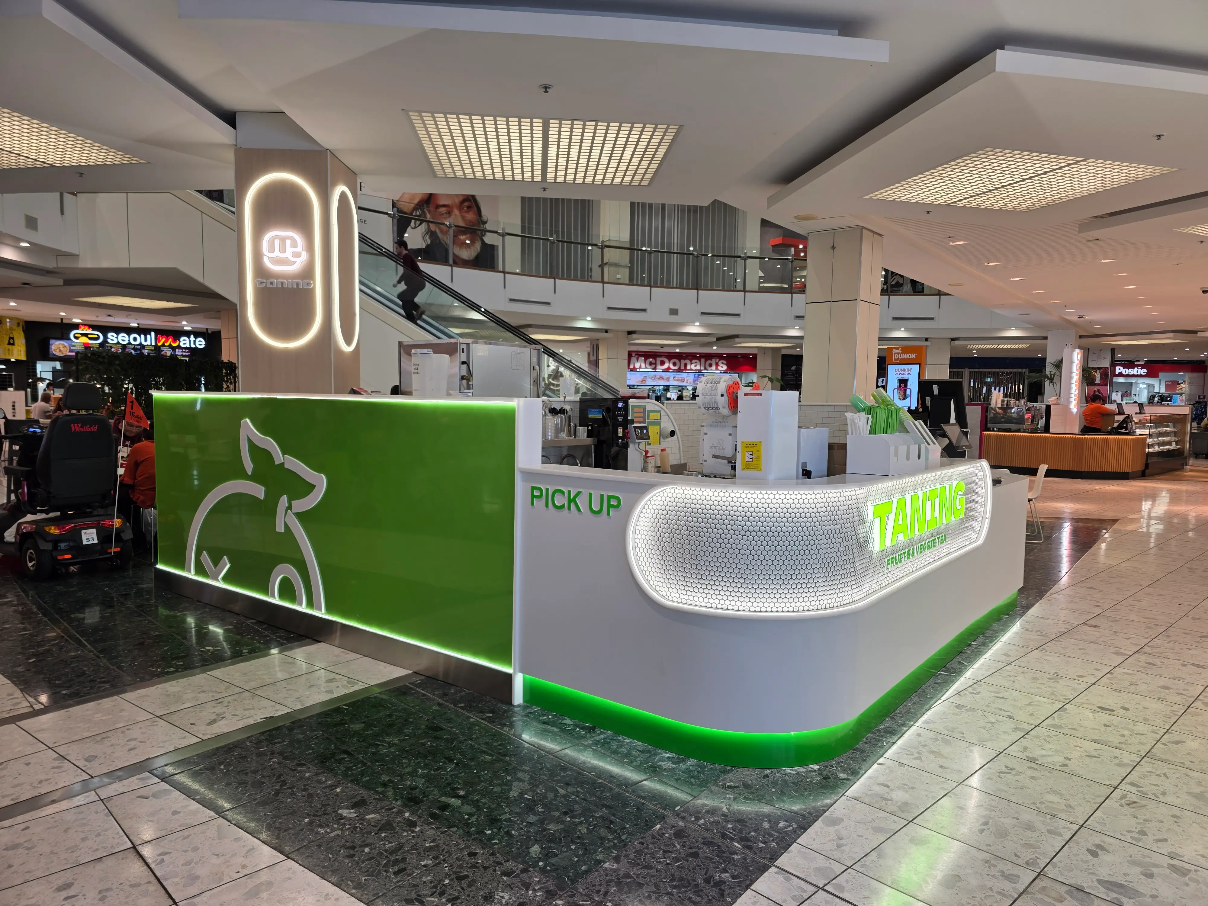Curved illuminated kiosk at Tanning Westfield St Lukes.