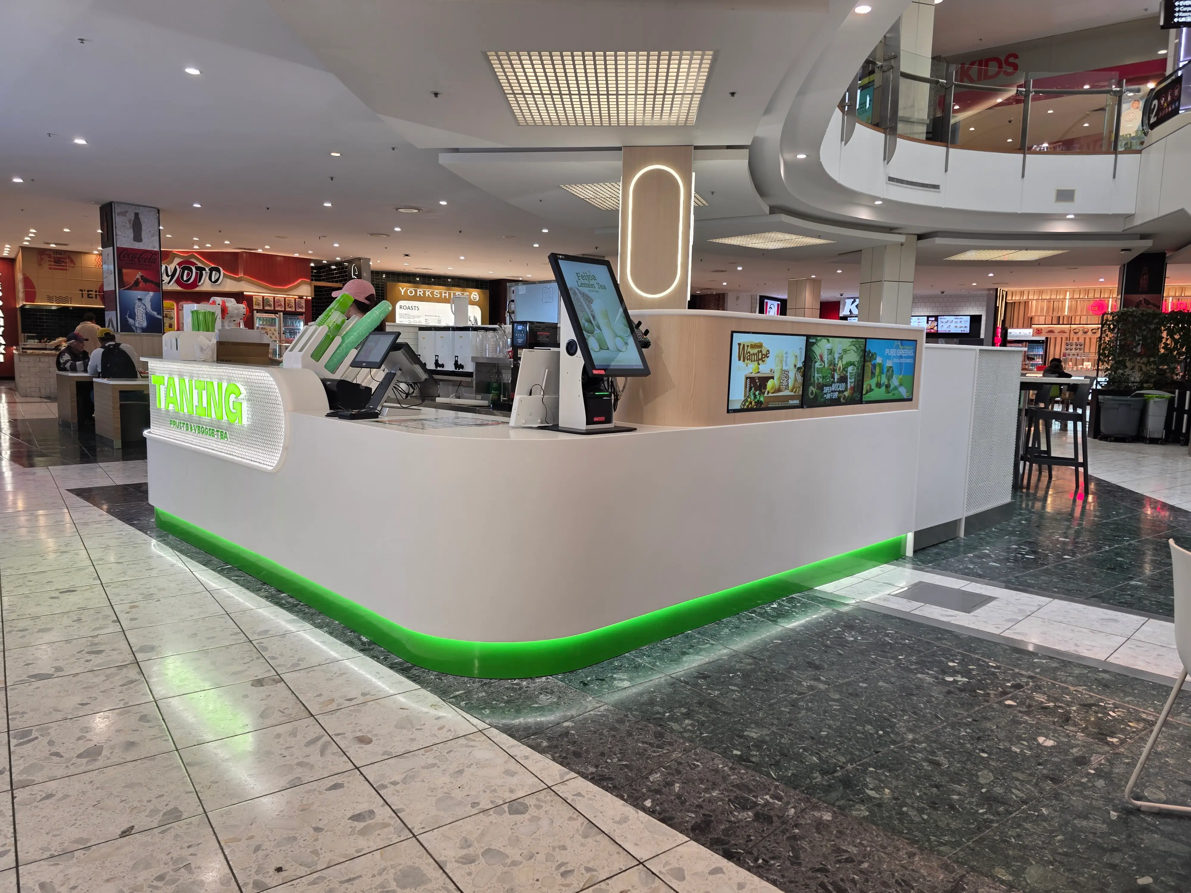 Curved illuminated kiosk at Tanning Westfield St Lukes.