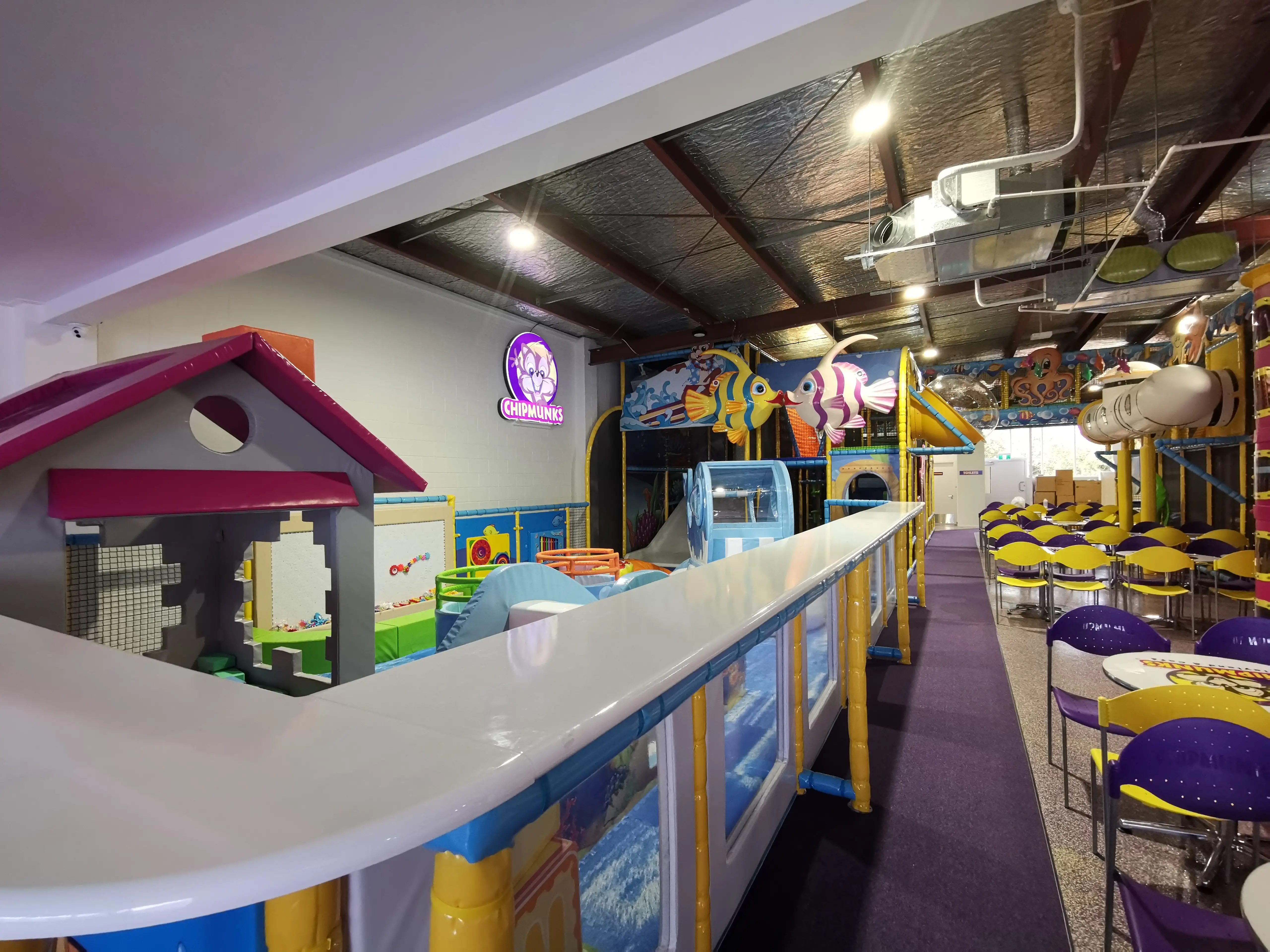 Colourful indoor play structures and family seating within the completed fit-out.