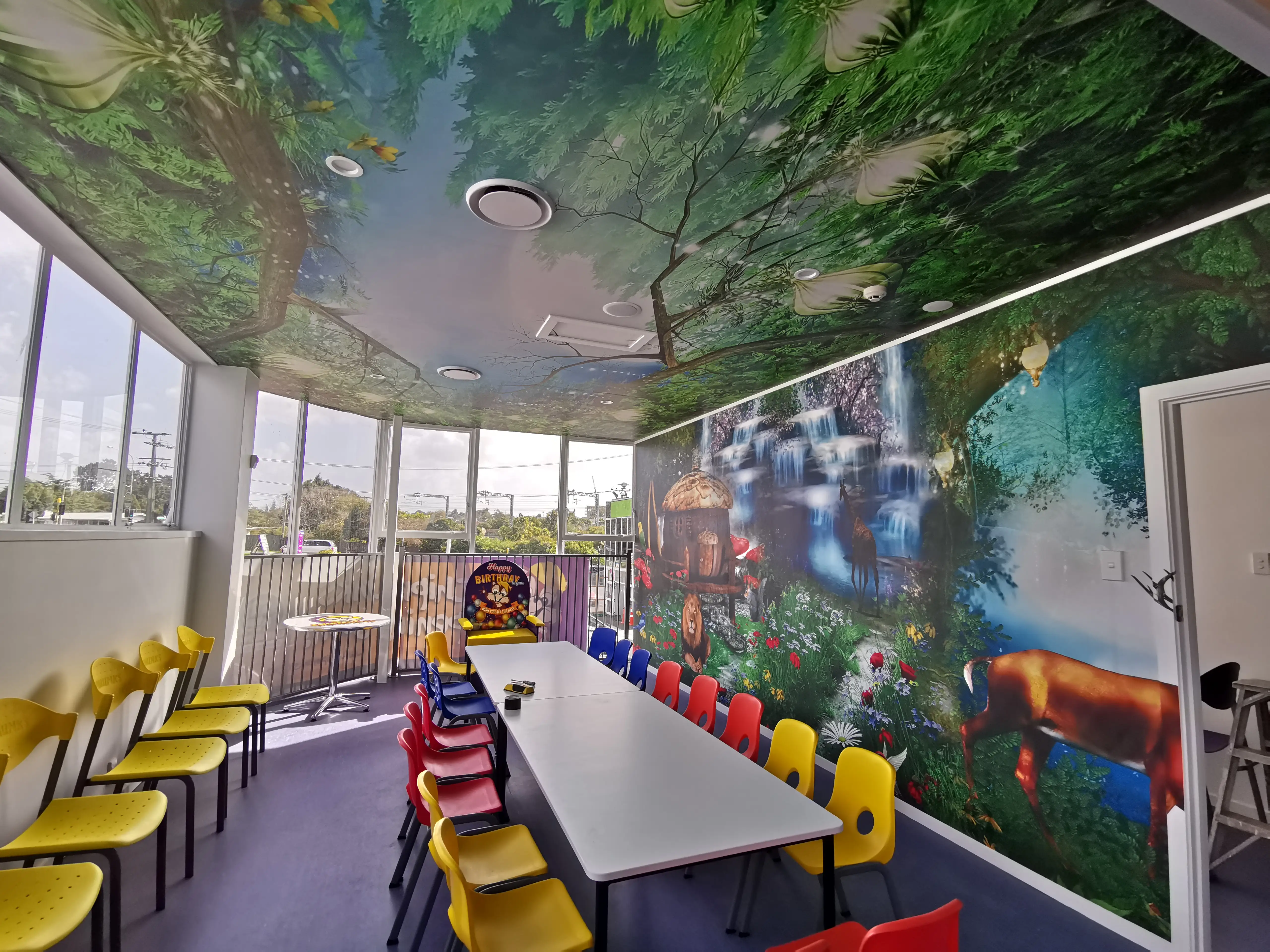 Colourful indoor play structures and family seating within the completed fit-out.