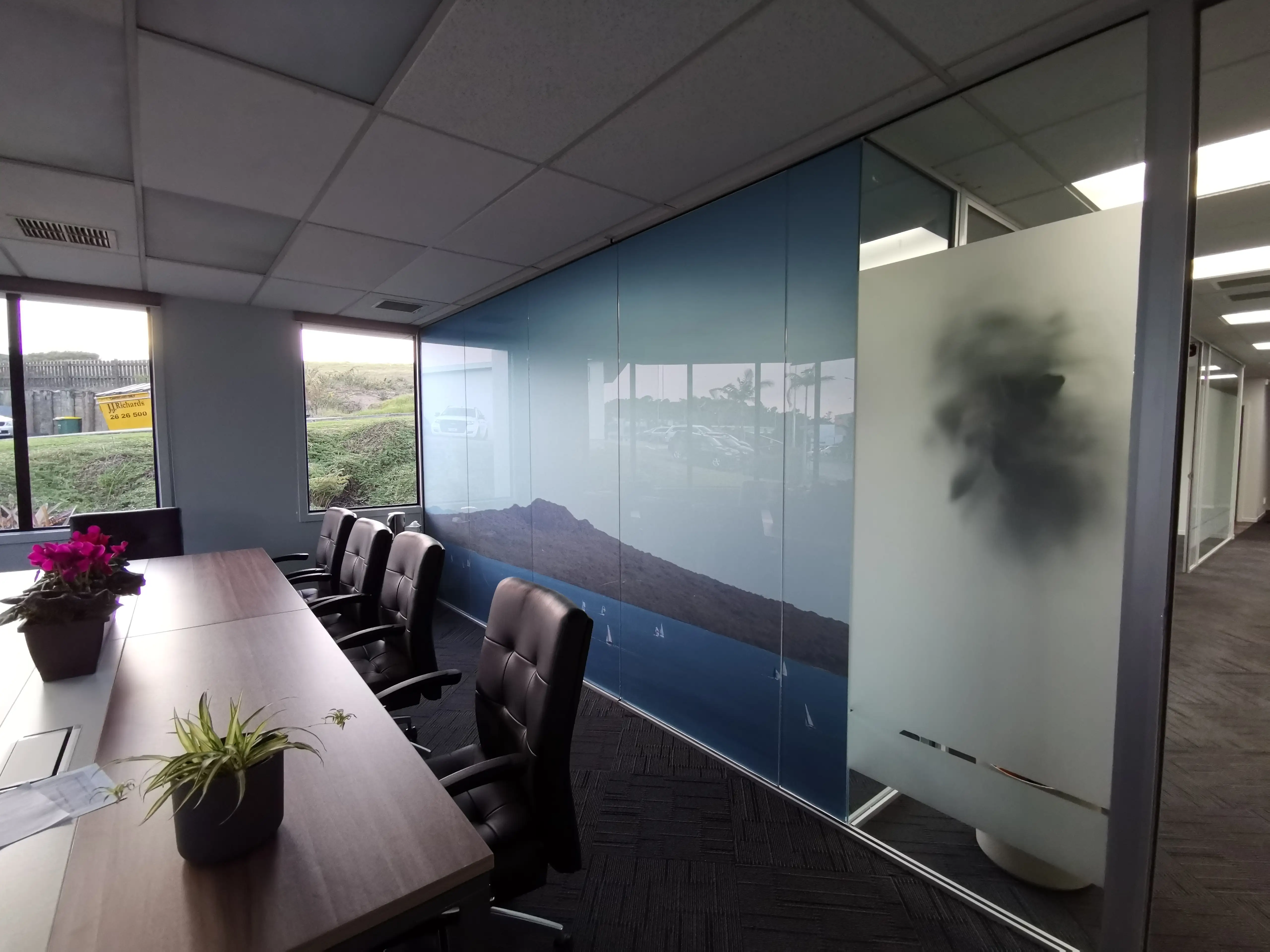 Long Champ Group meeting room with branded environmental graphics.