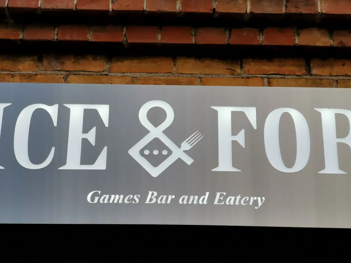 Venue lettering and graphic mark within the hospitality interior.