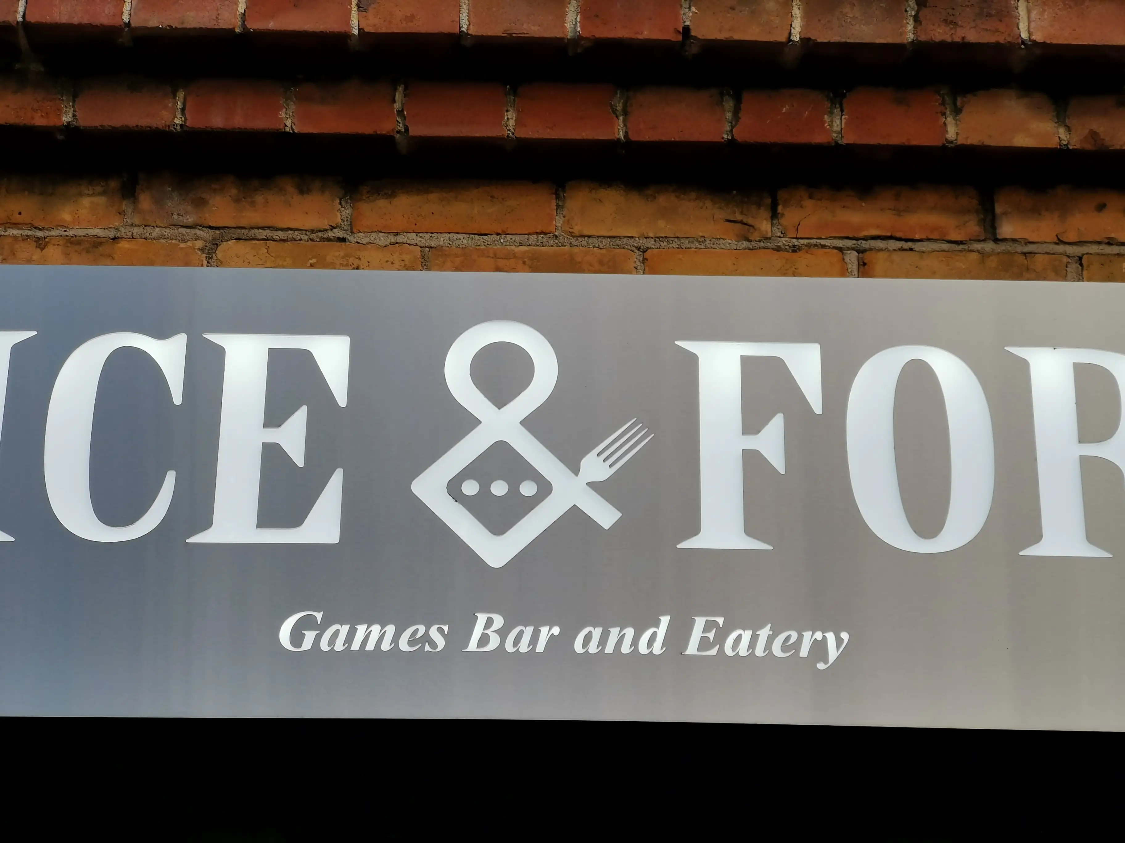 Venue lettering and graphic mark within the hospitality interior.