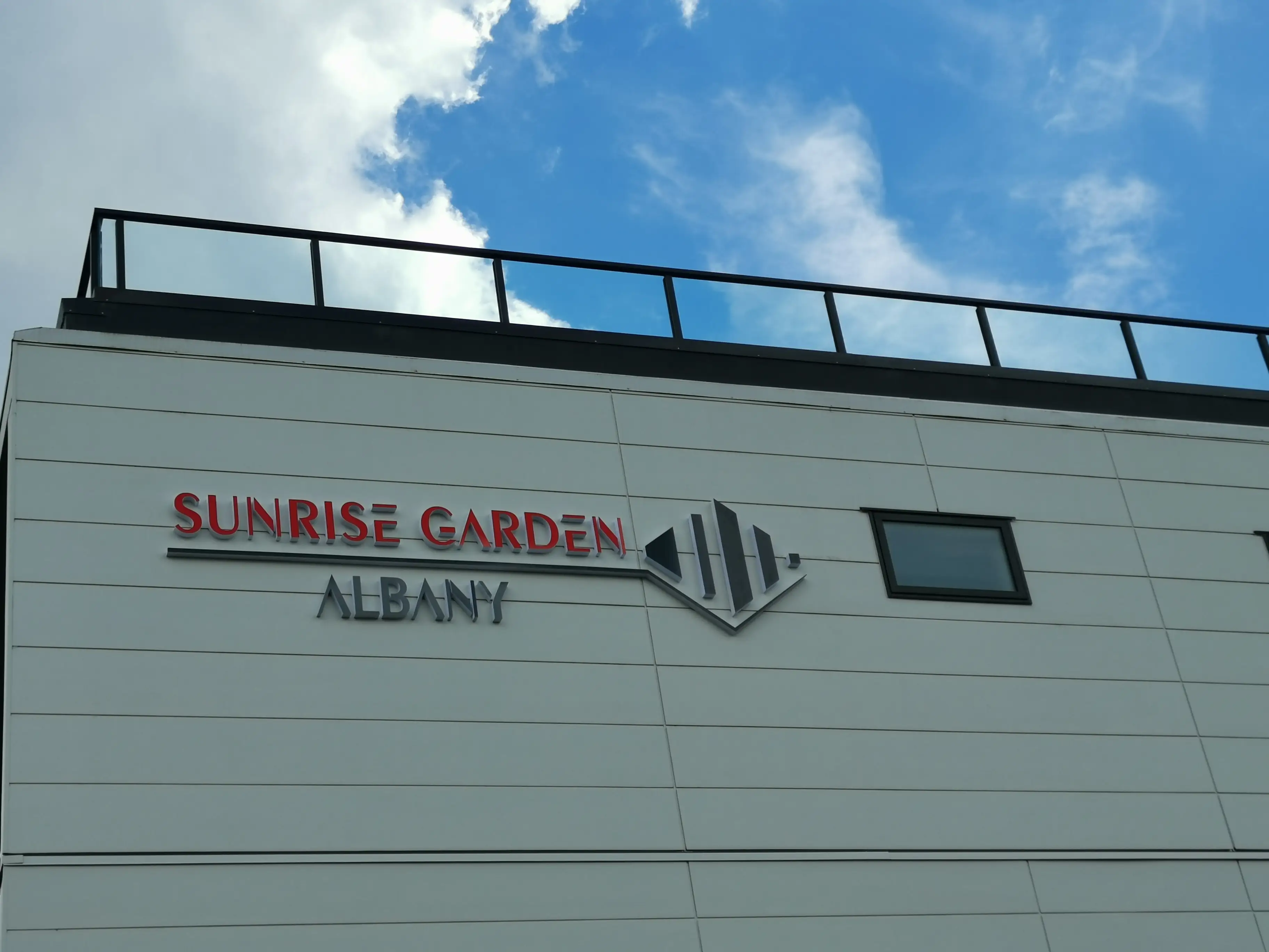 Sunrise Garden freestanding sign with dimensional red lettering.