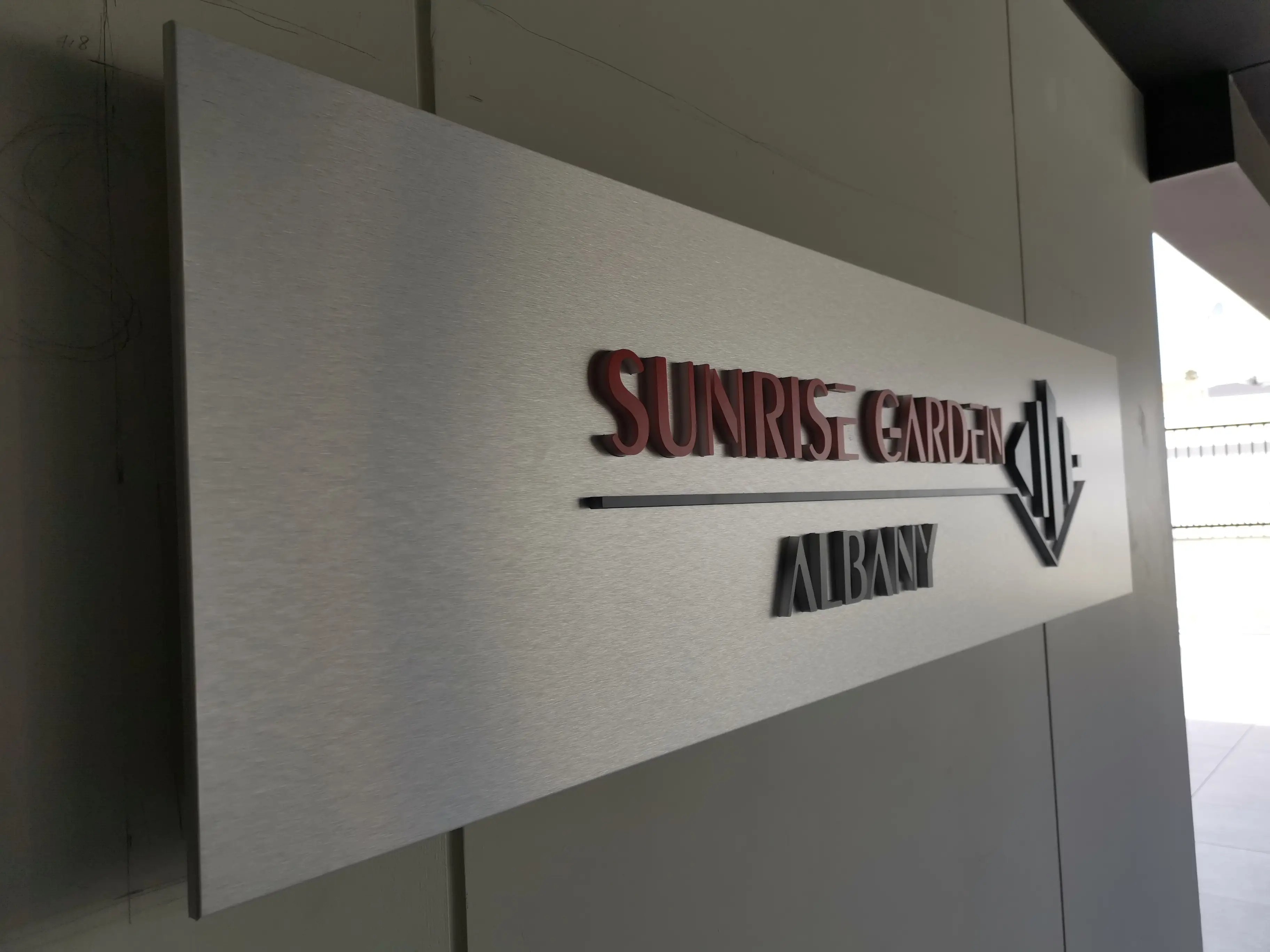 Sunrise Garden freestanding sign with dimensional red lettering.
