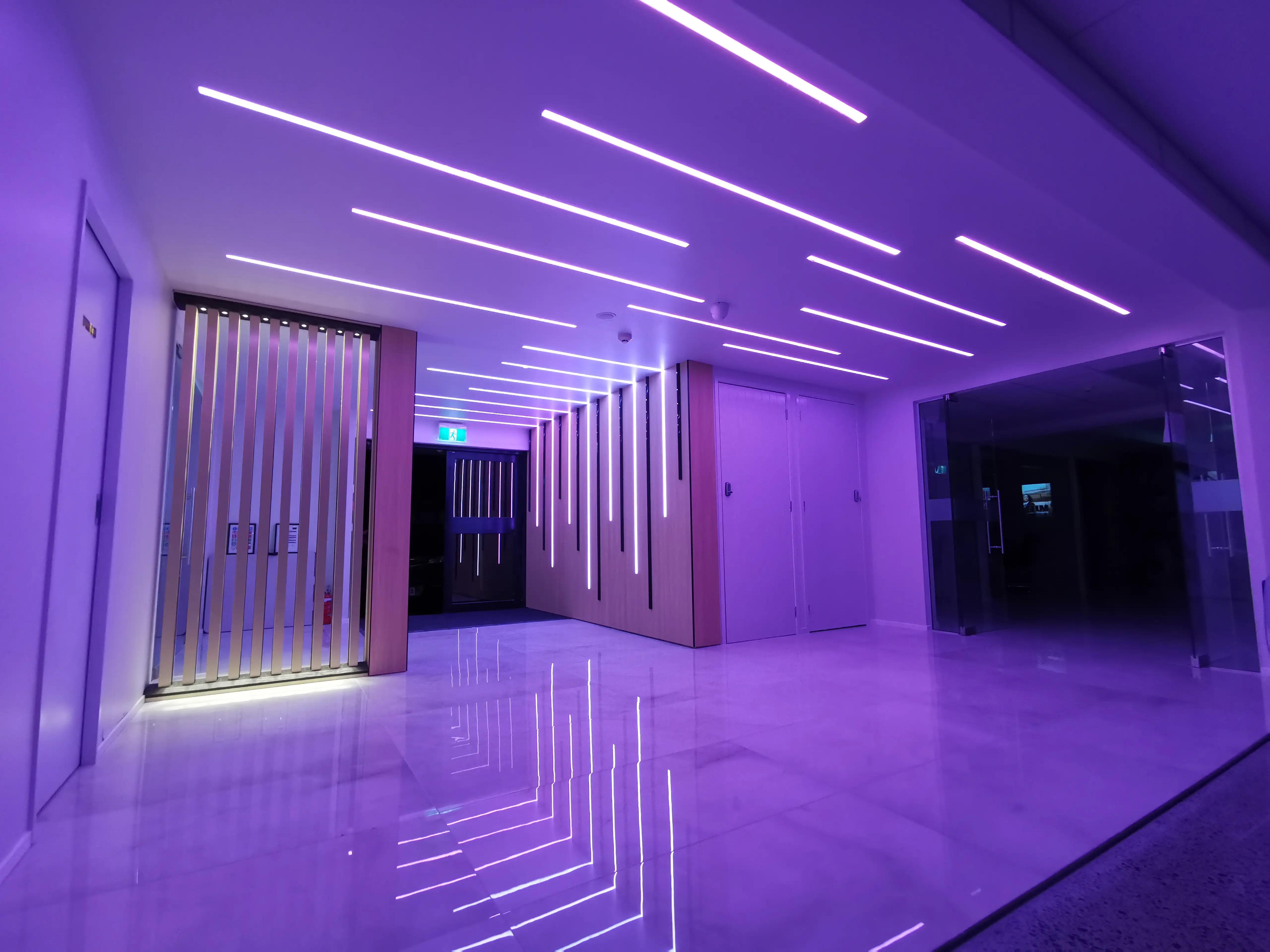 AZAK Cars showroom with linear ceiling lighting and a reflective floor.
