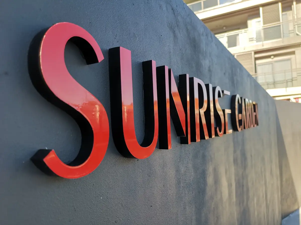 Sunrise Garden freestanding sign with dimensional red lettering.