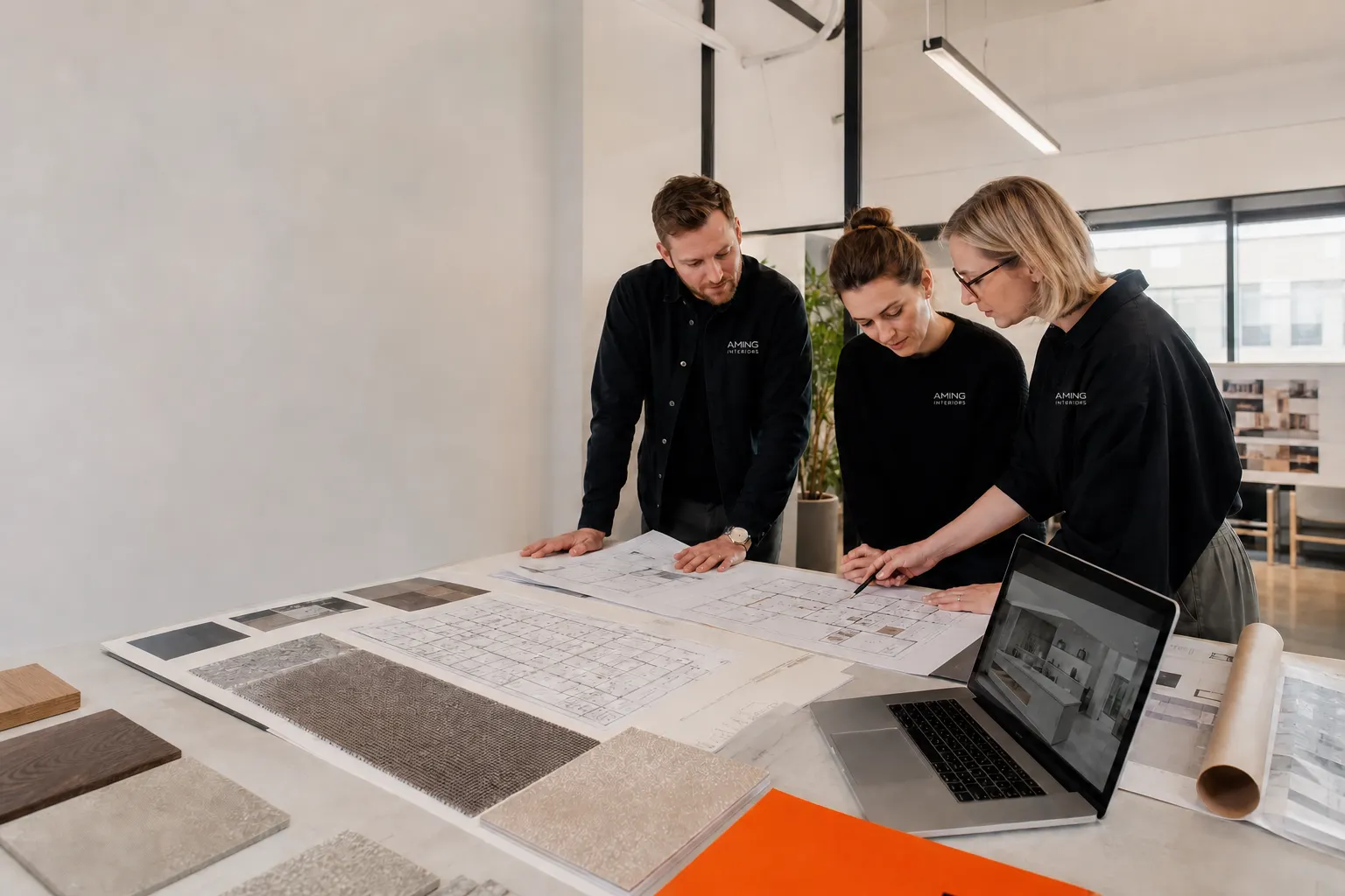 AMING design team reviewing a commercial layout and material samples