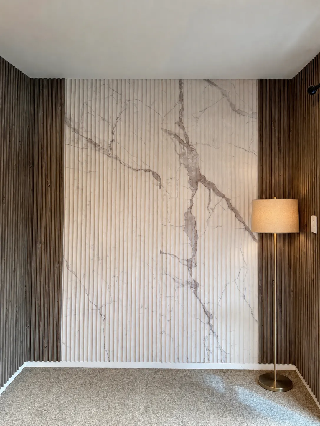 Supplier reference showing a white fluted marble-look feature wall framed by dark timber slats