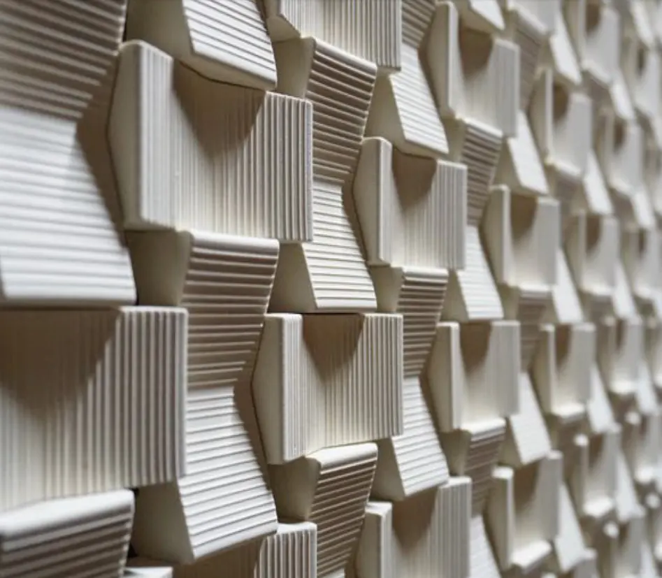 Close supplier reference of pale ribbed Seesaw three-dimensional wall tiles
